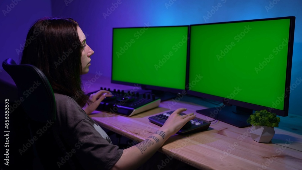 Portrait of female model looking at monitors and editing video using special equipment.. Advertising area, workspace mockup. Portrait of female model looking at monitors and editing video using special equipment.. Advertising area, workspace mockup.