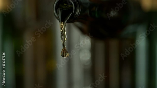 Super Slow Motion of Pouring White Wine With Camera Motion. Filmed on High Speed Cinema Camera, 1000 fps. Camera Follows the Stream into Glass. photo
