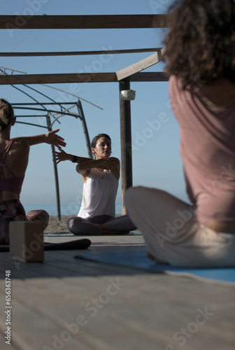 girl giving yoga class stretching