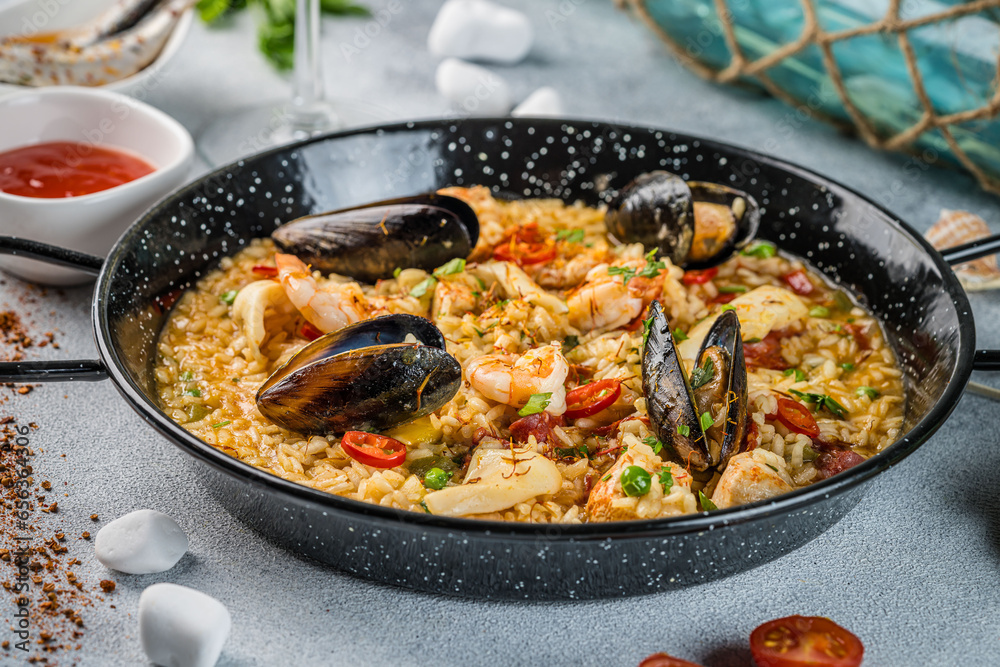 Italian Cuisine. Greek seafood and rice paella with shrimp, mussels and squid. on a light background