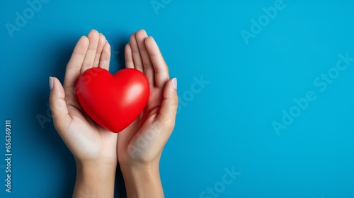 Heart Disease Prevention - Medical Gloves Holding Heart Model on Light Blue Background