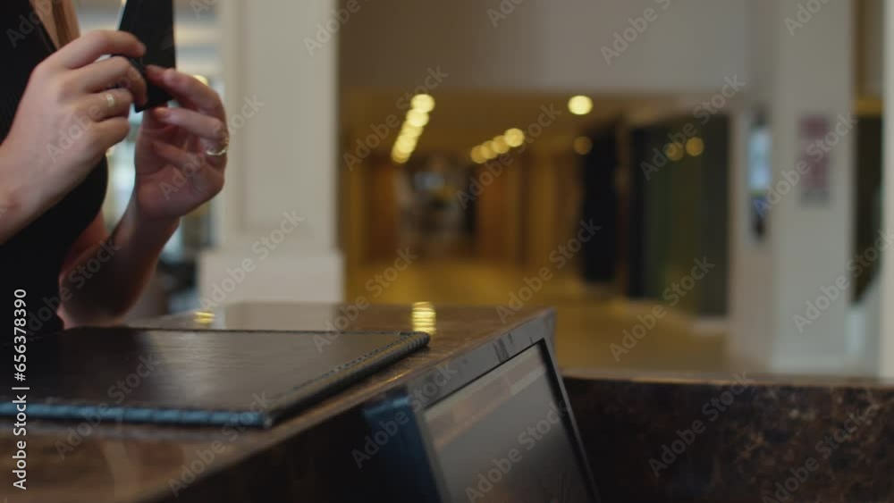 Close up of hands of woman getting key cards from rooms, checking in at hotel reception zone Close up of hands of woman getting key cards from rooms, checking in at hotel reception zone