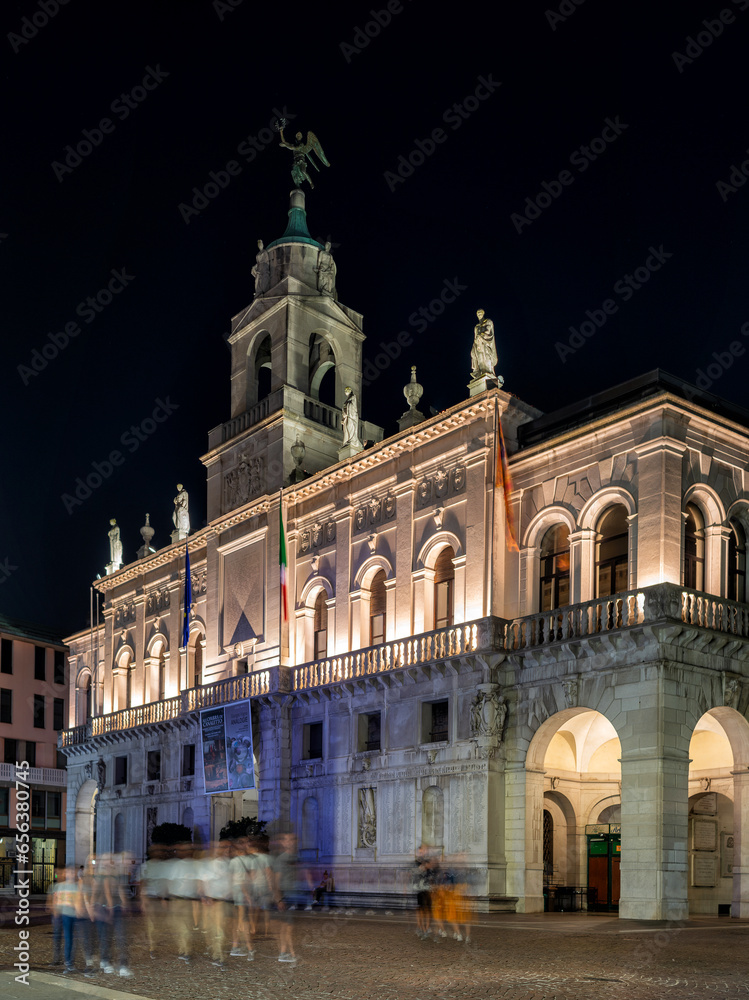 Padua, Italy - October 1, 2023: The Palazzo Comunale dal Liston: the Moretti-Scarpari Wing and the Palazzo degli Anziani with the Torre degli Anziani in the evening