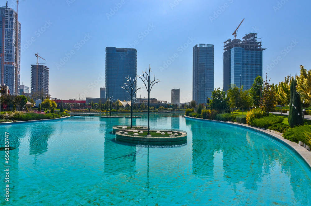 skyscrapers and lake with turquoise water in Tashkent City Park (Tashkent, Uzbekistan)