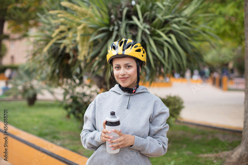 hispanic woman with a bike helemet photo