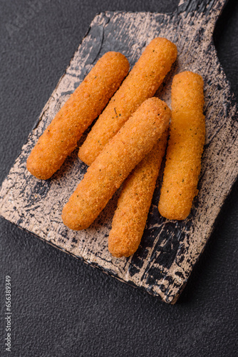 Delicious crispy cheese sticks with mozzarella, salt and spices, breaded and fried in oil