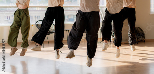 girls dancing crew in the gym jump in the air, choreo, synchrone moves photo