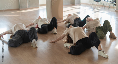 dance crew of girls doing moves on the floor, parter dance photo