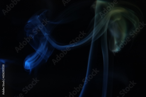 Yellow and blue smoke on a dark background, colourful abstract, one line, minimalistic art 