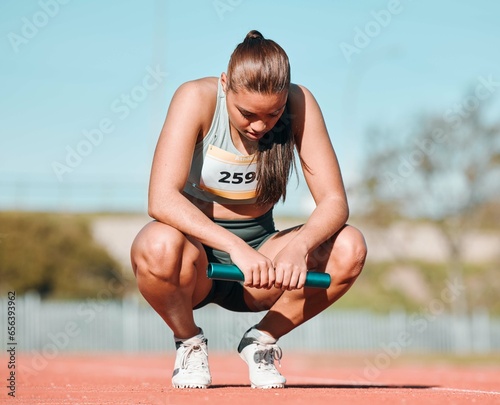 Fototapeta Naklejka Na Ścianę i Meble -  Fitness, relax and woman athlete on track for a relay race, marathon or competition at a stadium. Sports, workout and young female runner resting with a baton for an outdoor cardio training exercise.