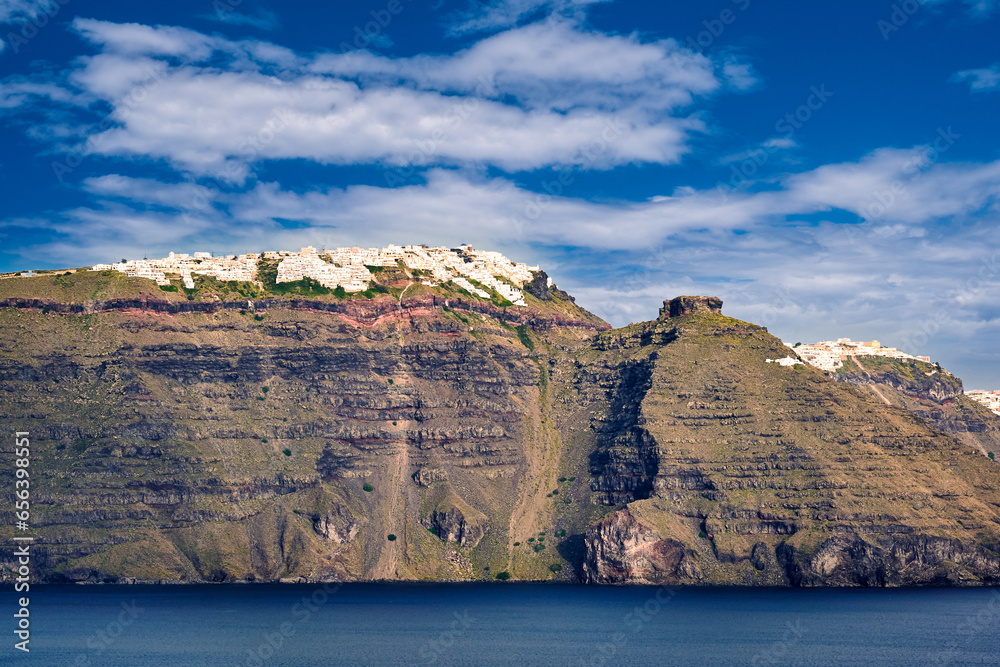 Panorama of Santorini, Greece, on sunny day, white towns atop cliffs