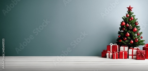 A large blue wall with a decorated christmas tree and gifts on one side is providing lots of negative space as background for text, graphics and personal messages