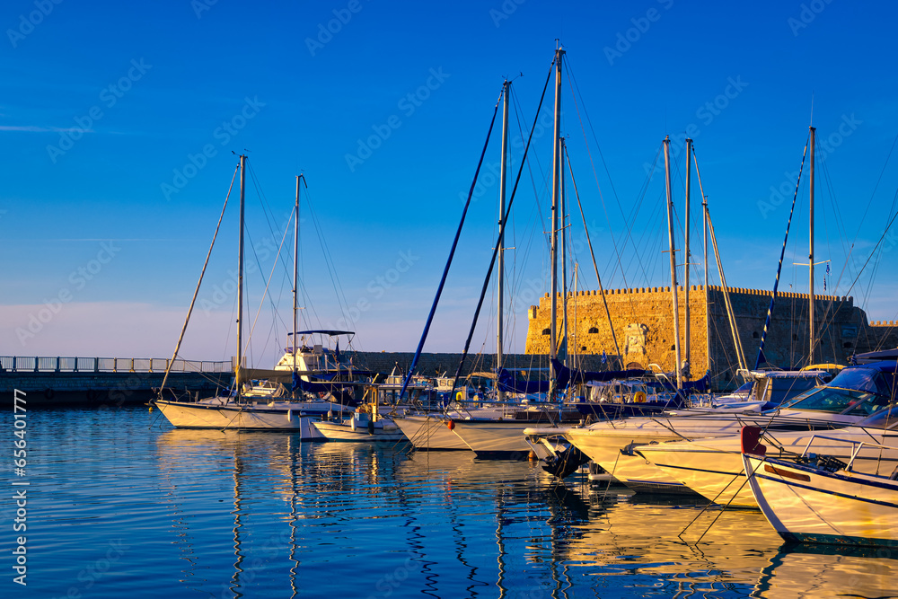 Venetian castle and fishing boats in bay of Heraklion, Crete, Greece