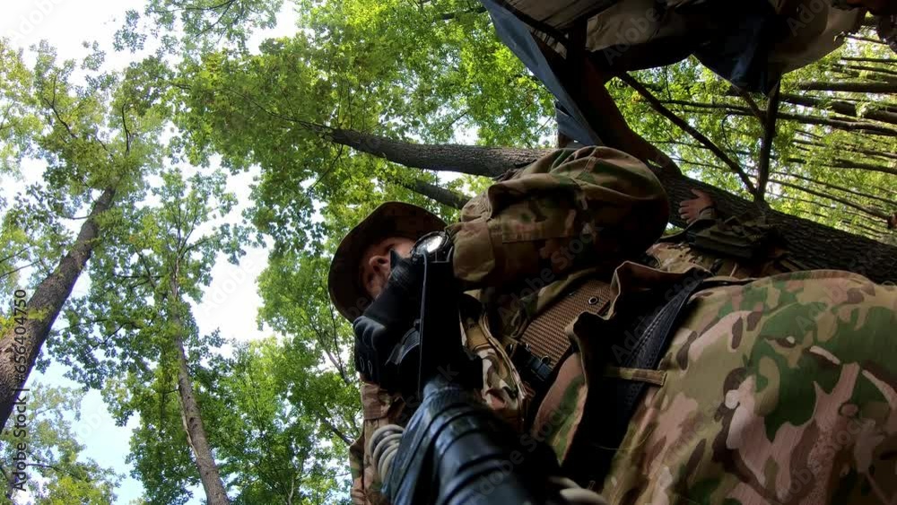 POV Close-up group of soldiers aiming with gun while moving through forest during military action. Squad of equipped fighters in camouflage uniform in forest. POV Close-up group of soldiers aiming with gun while moving through forest during military action. Squad of equipped fighters in camouflage uniform in forest.