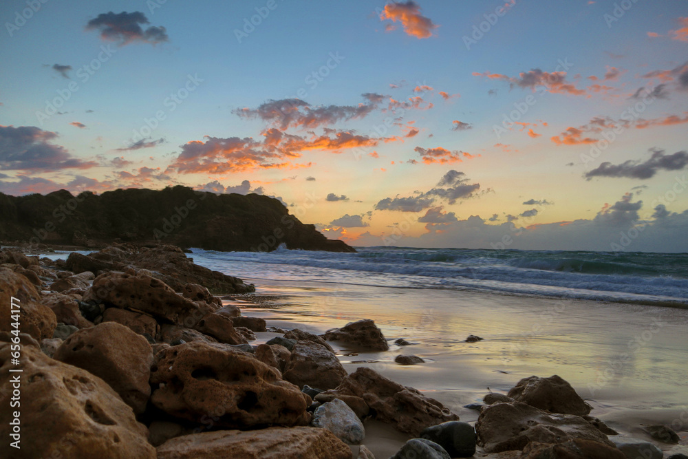 Sunset on the long rocky shore