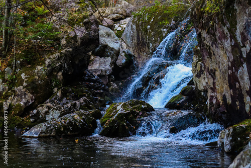 Waterfall. Tourism and travel in autumn. Holidays in the mountains.