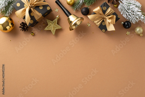 Extravagant Holiday Wishes theme. Top view of deluxe gift parcels, upscale tree embellishments, balls, star adornment, bright confetti, bell, frosty fir branches on terracotta surface with text space