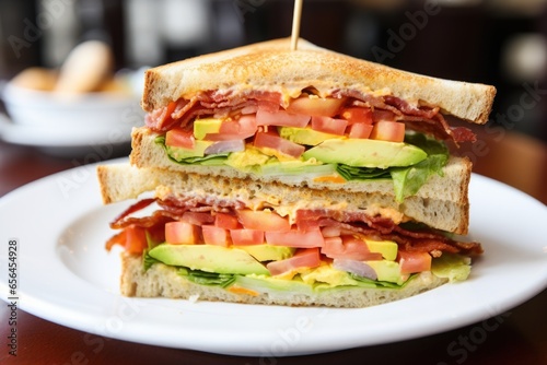 a bite-taken clubhouse sandwich showing different layers