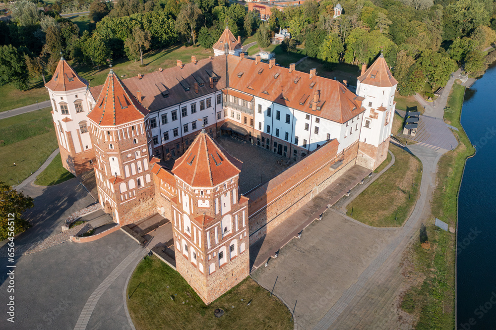 Belarus. Castle Mir complex historical and cultural monument of Belarus. Aerial view of a medieval castle on a bright sunny autumn day. Operating museum. Old architecture in colorful park view from ab