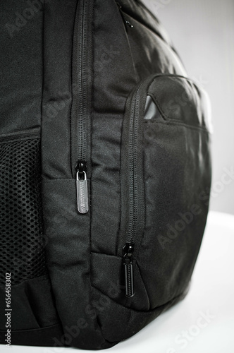Voluminous black backpack and zipper from the lock close-up
