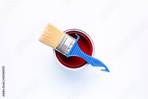 red open paint can with brush on it isolated on white background