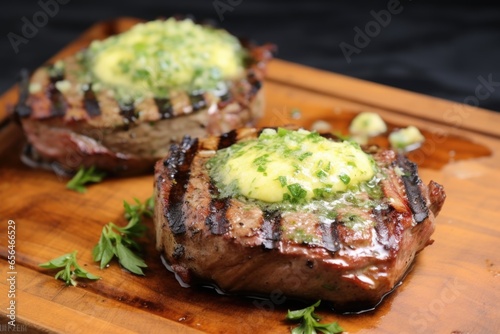 pair of grilled chops with herb butter melting on top