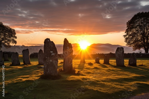 sunrise over a standing stone circle