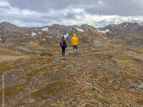 Two travelers hiking in the wild nature of Mageroya Island, Norway