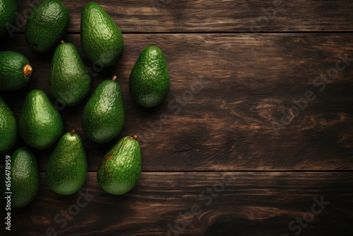 A bunch of fresh green avocados displayed on a rustic wooden table. Perfect for food and healthy eating concepts.