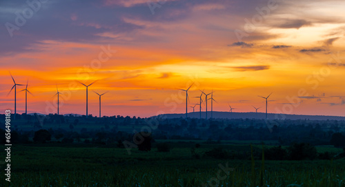 Landscape Windmill on a mountain with vast meadows at sunset  beautifully illuminated.