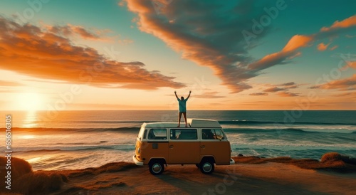 A man stands on the roof of a minivan on the beach photo