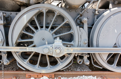 Close-up of the wheels of an old steam train locomotive from the 1940s