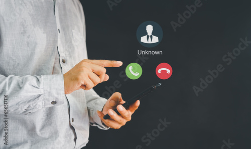 Unknown number calling in the middle of the night. Phone call from stranger. Man answering to incoming call. Phone call from unknown number. Call center gang, scammer or stranger. photo