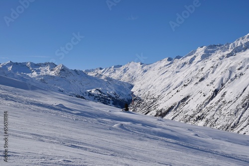 Beautiful view of the snowy Ötztal Valley, Tyrol, Austria during peak ski season in the winter. Shot from Hochgurgl ski resort on a beautiful sunny day. © Elenitsa