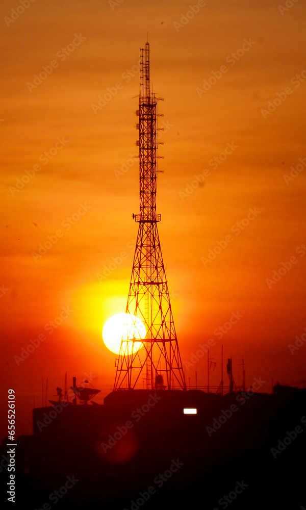 Mobile communication tower during sunset