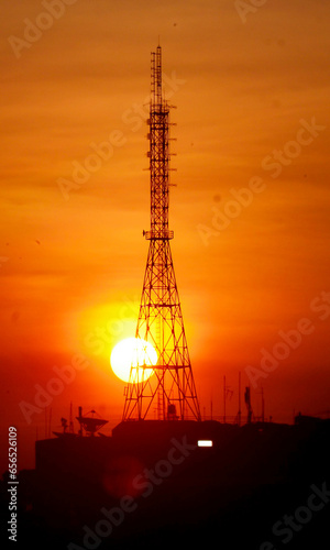Mobile communication tower during sunset