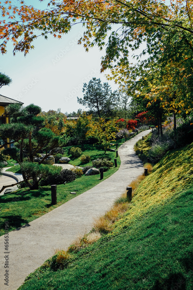 Japanese Garden Krasnodar in Russia, Japan during September before autumn. The leaves are turning from green to orange. Footpath. Japanese Garden Krasnodar in Russia, Japan during September before autumn. The leaves are turning from green to orange. Footpath.