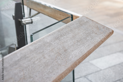 Wooden railing with tempered glass of walk way balcony.