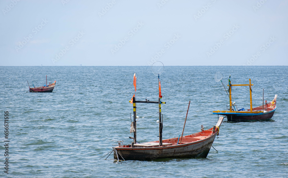 Fishing boats used to catch fish Located on sea water with slight waves. Used to find food for people who earn a living catching fish. For those who live next to the sea