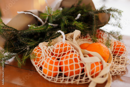Bouquet of christmas tree banches and bag with mandarins photo