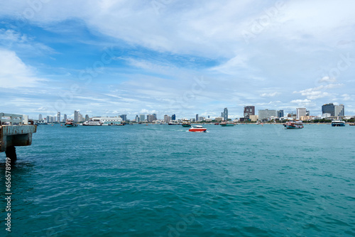 Fototapeta Naklejka Na Ścianę i Meble -  Landscape of Pattaya Bay and Pattaya city during the daytime with speedboat tour boats moored in the bay.