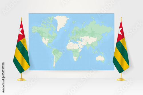 World Map between two hanging flags of Togo flag stand.