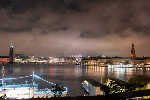 Stockholm  Sweden  city lights and night view of Stadsholmen district  Gamla Stan  and Riddarholmen district  buildings reflected in the water. Cityscape with illumination  Riddarfjarden marina