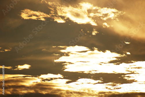 Golden clouds on the background of a bright sunset