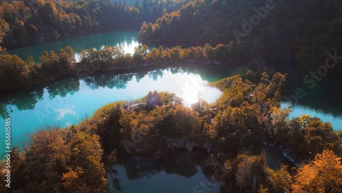 Mountain lake in autumn forest with bright landscape at sunny morning. Clear fresh turquoise water in reservoir. © Igor Tichonow