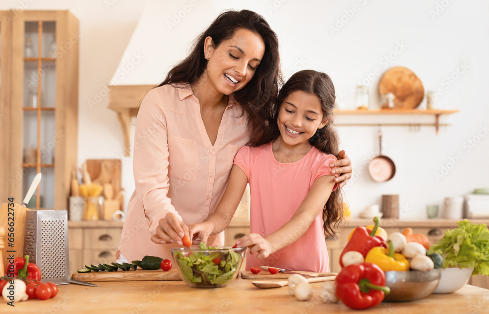 Cheerful Woman Hugging Daughter Enjoying Cooking Leisure Making Salad Indoor Cheerful Woman Hugging Daughter Enjoying Cooking Leisure Making Salad Indoor