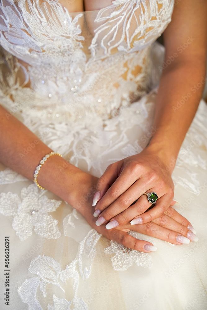 hands of the bride with white fingernails and jewerlery hands of the bride with white fingernails and jewerlery