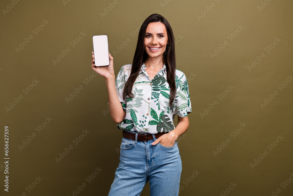 Naklejka premium Photo of gorgeous lovely lady wear stylish clothes hand hold demonstrate modern gadget empty space isolated on beige color background