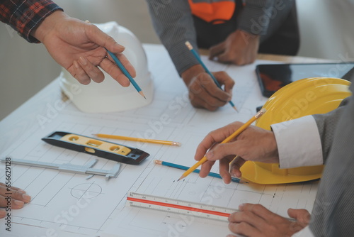 Construction and structure concept of Engineer or architect meeting for project working with partner and engineering tools on model building and blueprint in working site, contract for both companies.