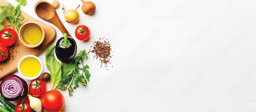 Assorted organic vegetables cooking spoons and oil on a white wooden background top view A banner representing healthy food vegan or diet nutrition with copyspace for text